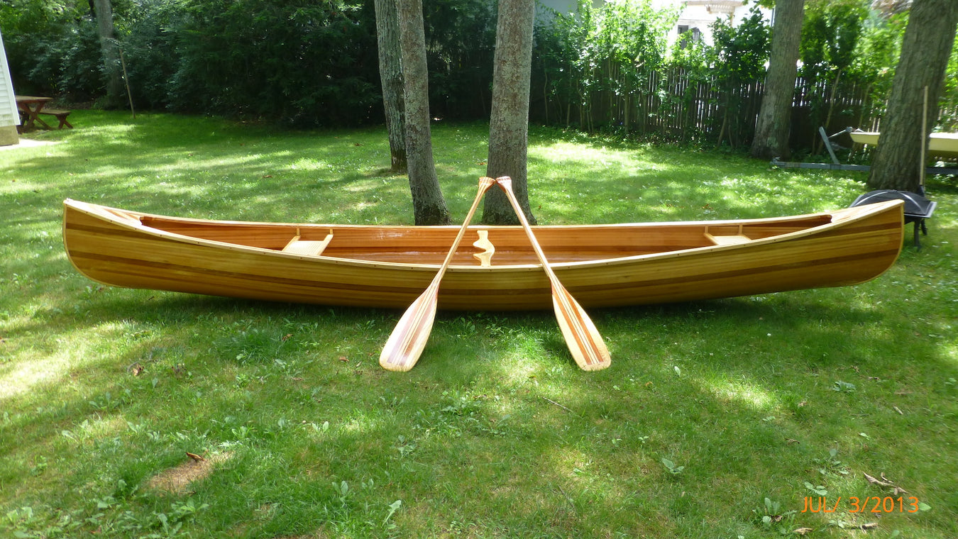 Cedar strip canoe with paddles